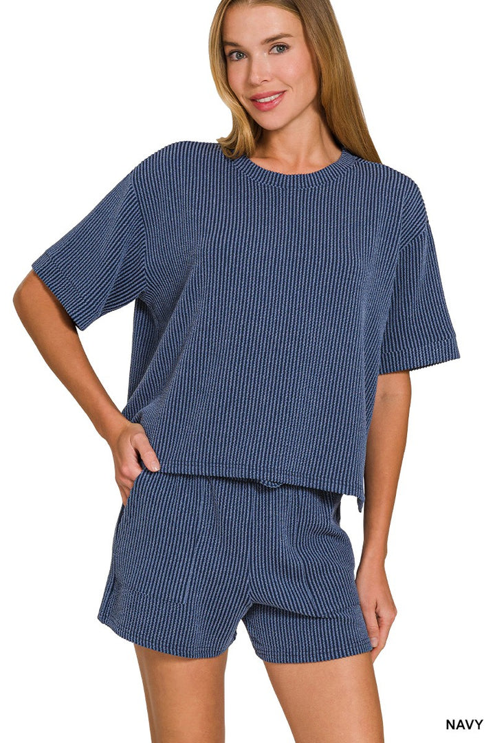 Woman wearing navy blue pajama set on a white background
