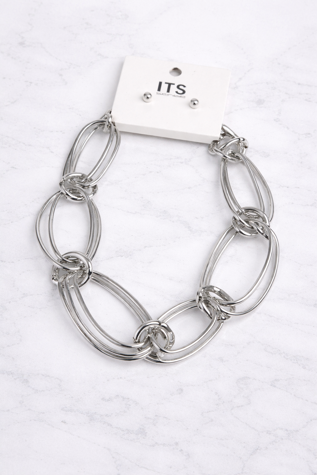 Silver chain bracelet on a white background with &