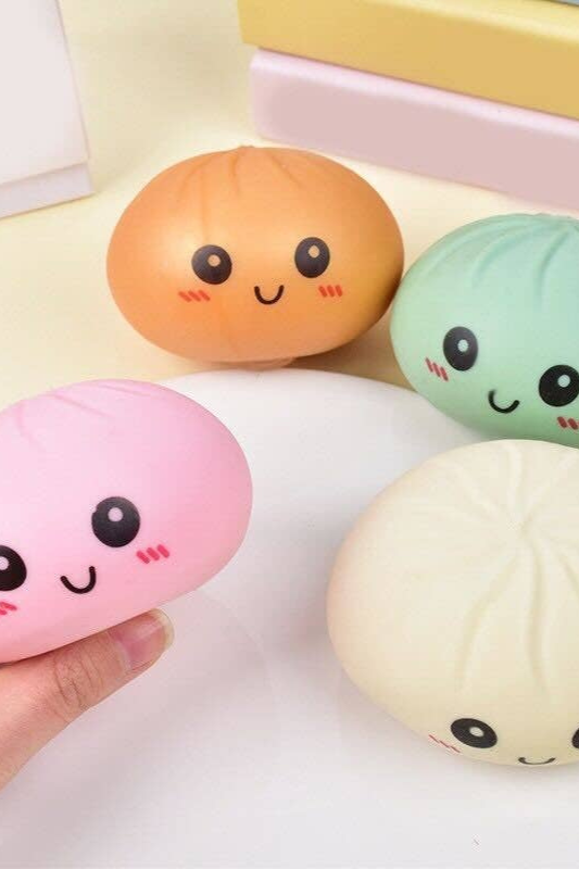 Four colorful squishy toys with cute faces on a light background