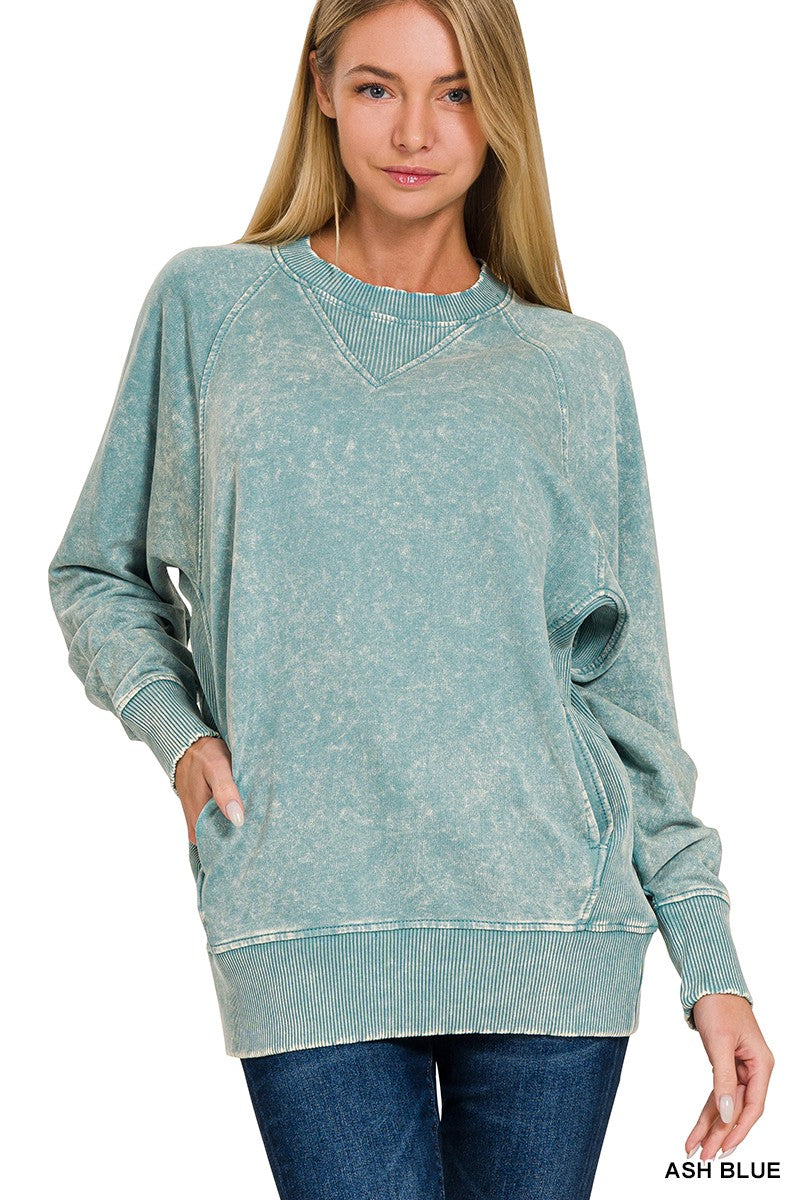 Woman wearing an ash blue sweatshirt on a white background
