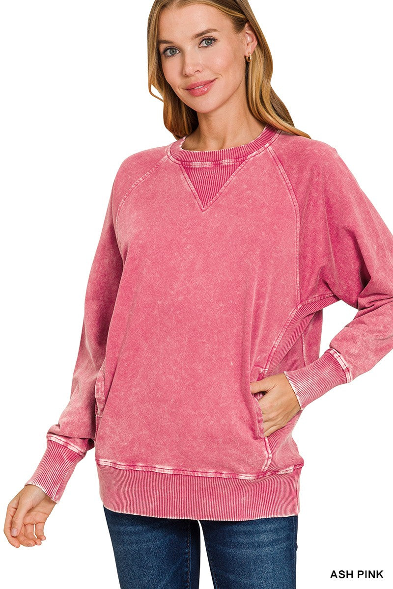 Woman wearing an ash pink sweatshirt with a white background