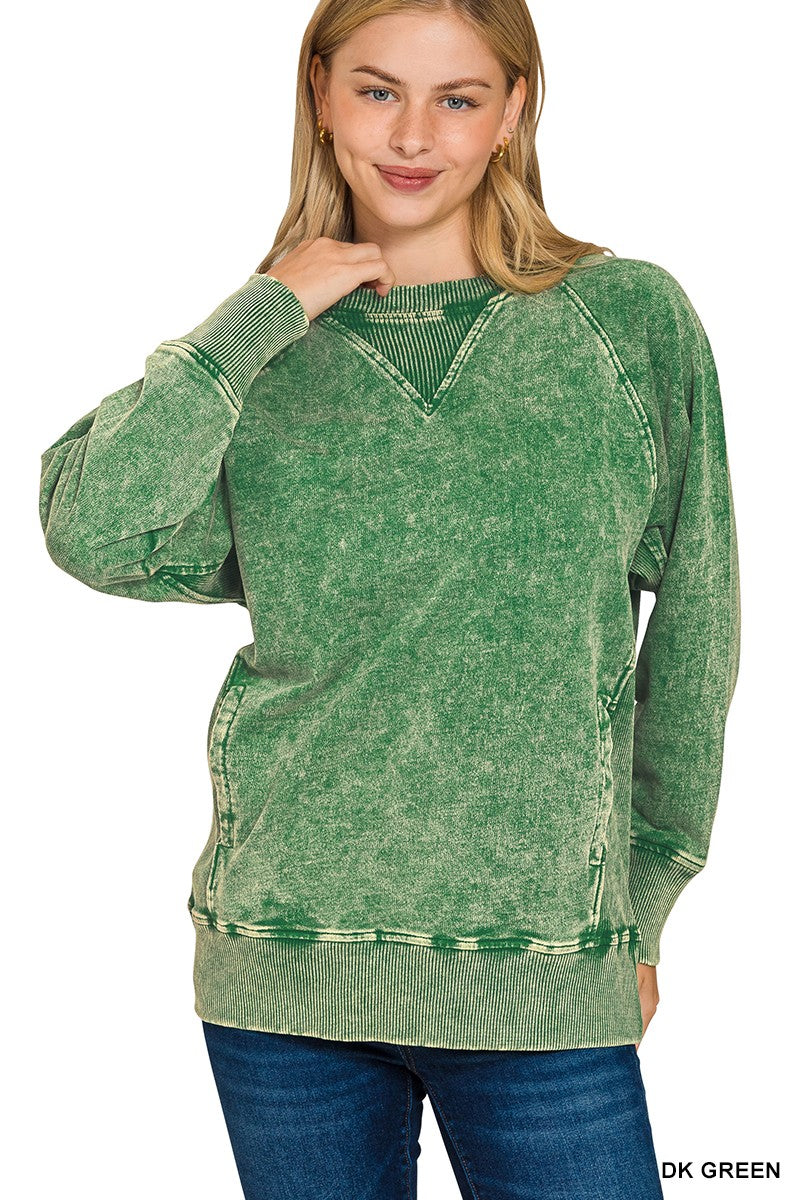 Woman wearing a green distressed sweatshirt on a white background