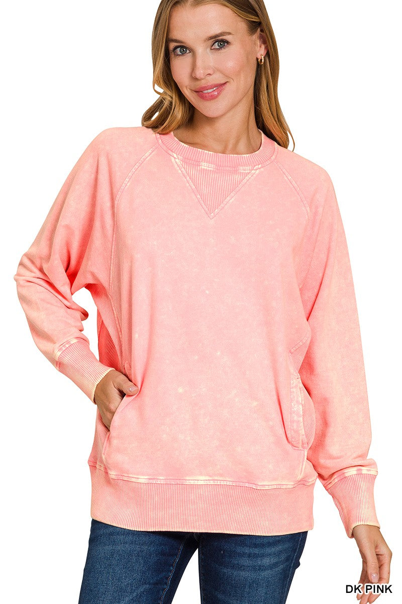 Woman wearing a pink sweatshirt with a white background
