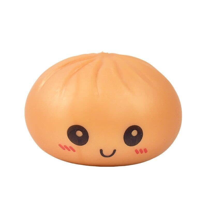 Squishy toy shaped like a peach with a face on a white background