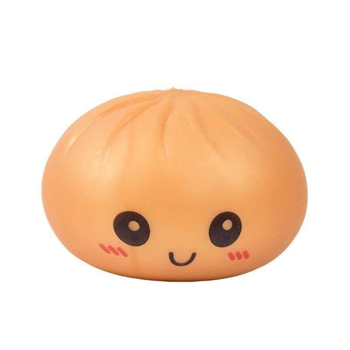 Squishy toy shaped like a peach with a face on a white background