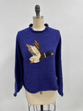 Blue sweater with a bird design on a mannequin against a white background