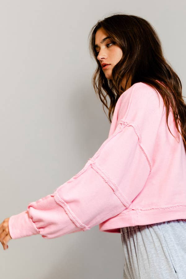 Woman wearing a pink jacket against a plain background