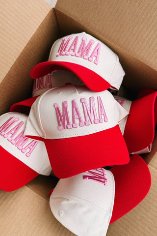 Red and white caps with 'MAMA' text in pink on a cardboard box.
