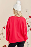 Person wearing a red sweater and white beanie with a neutral background