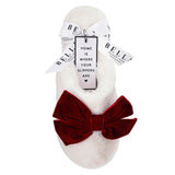 White slipper with a red bow and gift tag on a white background