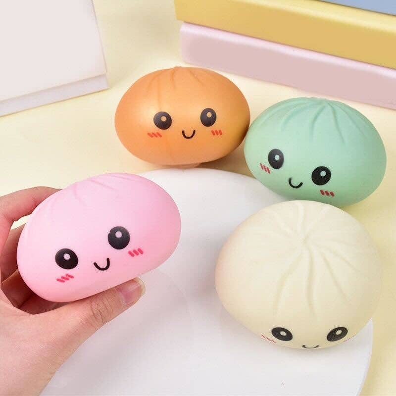 Four colorful squishy toys with smiling faces on a light background