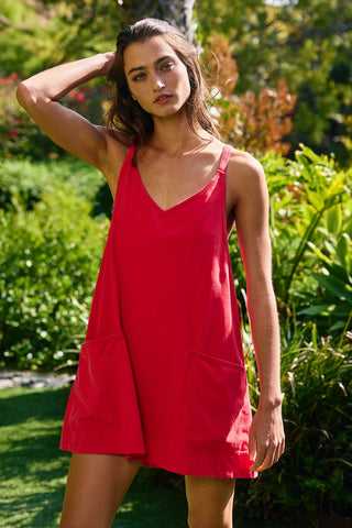 Woman wearing a red dress standing in a garden