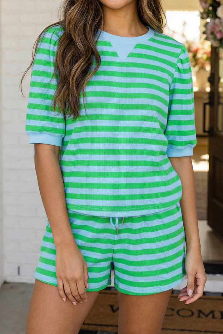 Person wearing a green and white striped outfit indoors.