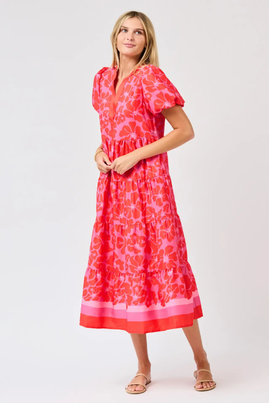 Woman wearing a red floral dress on a white background
