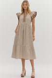 Woman wearing a striped dress with ruffled sleeves on a white background