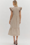Woman wearing a striped dress with ruffled sleeves on a white background