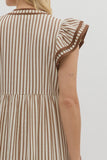 Brown and white striped dress worn by a person on a plain background