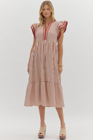 Woman wearing a striped dress on a white background