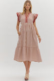 Woman wearing a red and white striped dress on a white background