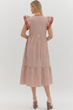 Woman wearing a red and white striped dress on a white background