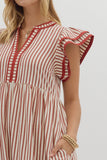 Red and white striped dress worn by a person on a plain background