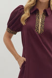 Maroon dress with leopard print accents on a plain background