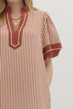 Red and white striped dress with a close-up of the neckline on a plain background