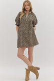 Woman wearing a patterned dress with puff sleeves and brown boots on a white background