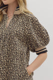 Leopard print dress with puff sleeves on a plain background