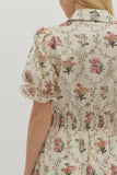 Floral patterned dress with ruffled sleeves on a plain background
