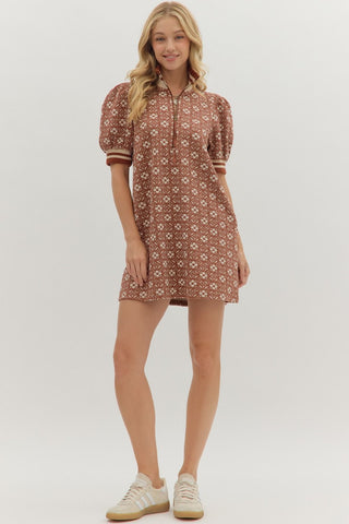 Woman wearing a patterned dress on a white background