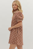 Woman wearing a floral dress with a plain background