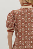 Person wearing a patterned dress with a white background