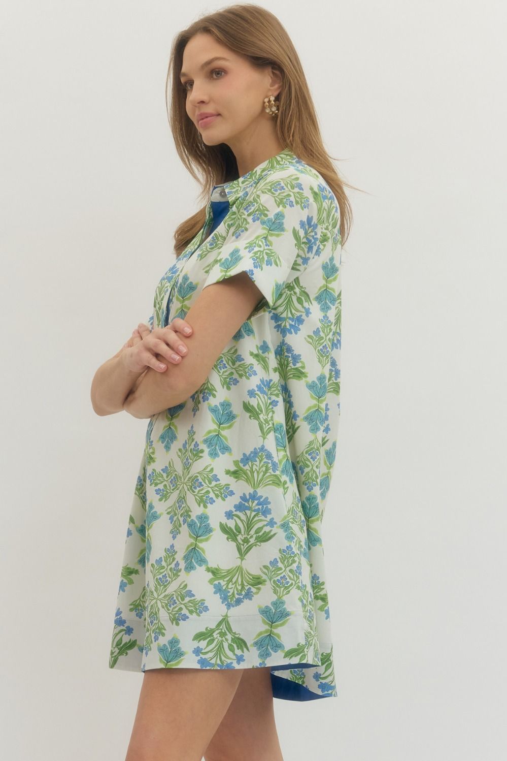 Woman wearing a floral dress with a plain background