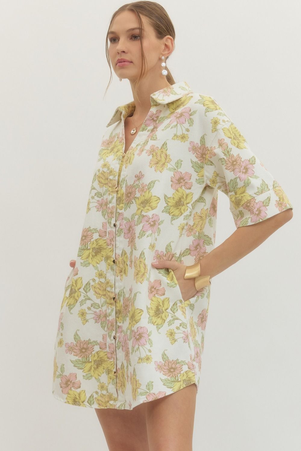 Woman wearing a floral dress on a plain background