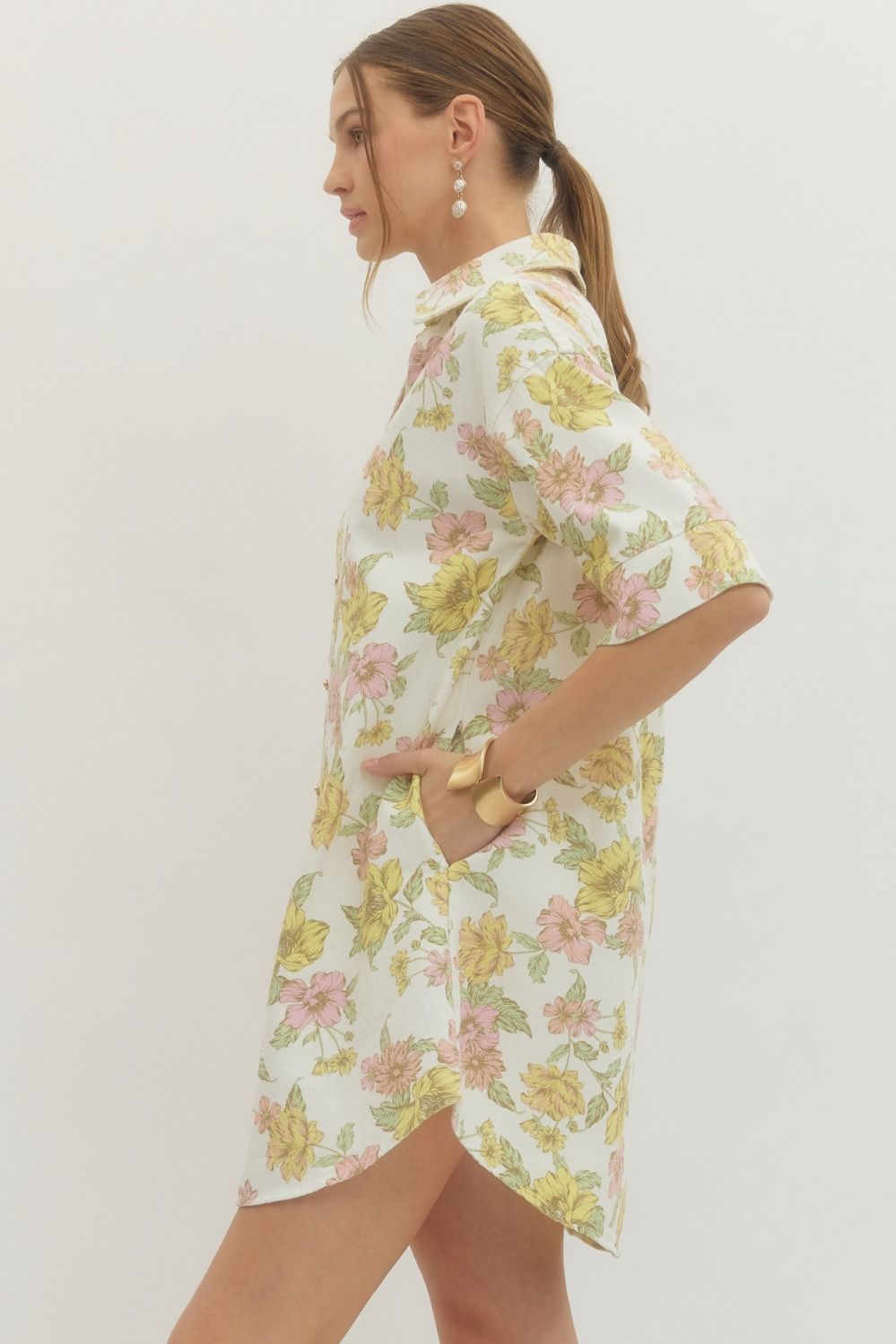 Woman wearing a floral dress with a plain background