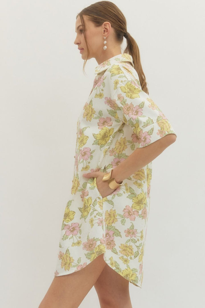 Woman wearing a floral dress with a plain background