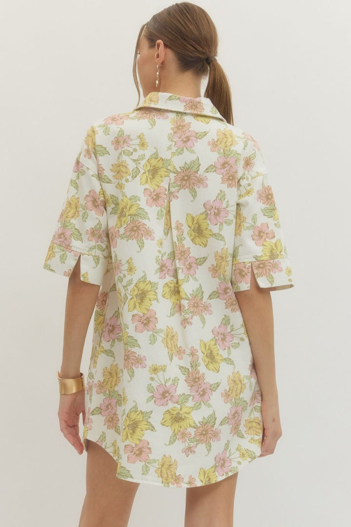 Woman wearing a floral dress with a plain background