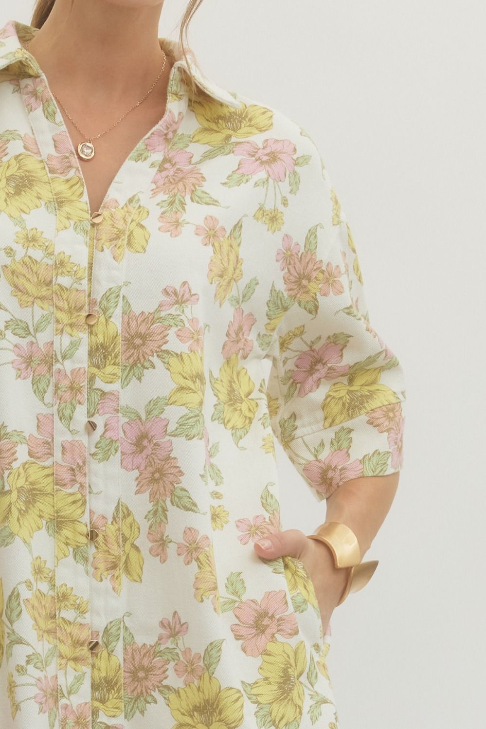 Floral patterned shirt worn by a person on a plain background