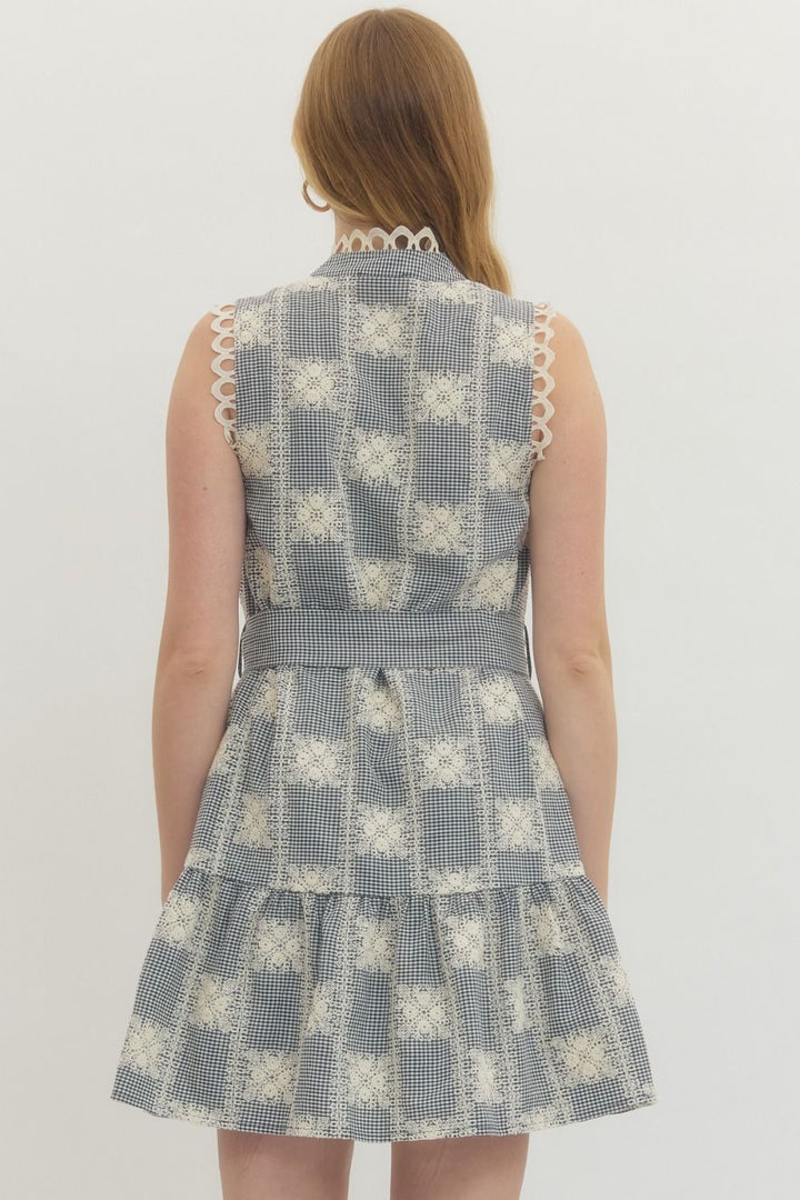 Woman wearing a patterned dress on a plain background