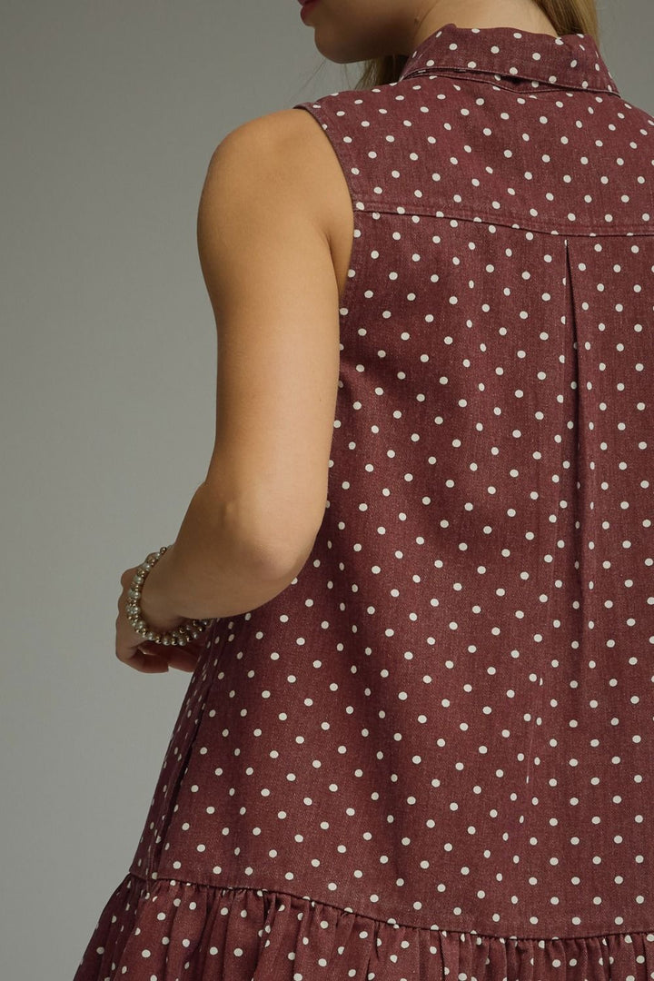 Maroon sleeveless dress with white polka dots on a gray background