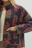 Navy blue floral-patterned jacket with pink flowers and green leaves on a plain background