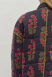 Floral-patterned quilted jacket on a plain background