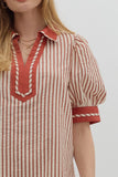 Red and white striped shirt with a V-neckline on a plain background