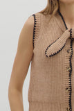 Beige knitted vest with button details on a plain background
