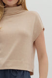 Beige sleeveless top worn by a person on a white background