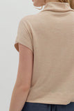 Beige sleeveless top worn by a person on a white background
