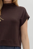 Brown sleeveless top worn by a person on a light gray background