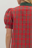 Red plaid shirt with green collar on a plain background
