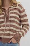 Brown and beige striped sweater worn by a person on a white background